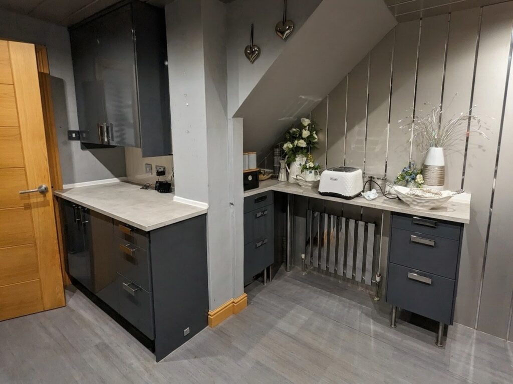 Commercial kitchen cabinets wrapped in dark grey architectural vinyl